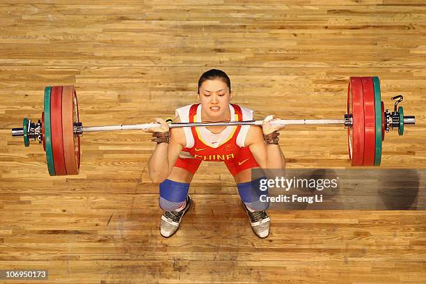 Cao Lei of China competes in the weightlifting Women's 75 kg Group A during day six of the 16th Asian Games Guangzhou 2010 at Dongguan Gymnasium on...