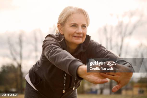 mature woman exercising - senior women yoga stock pictures, royalty-free photos & images