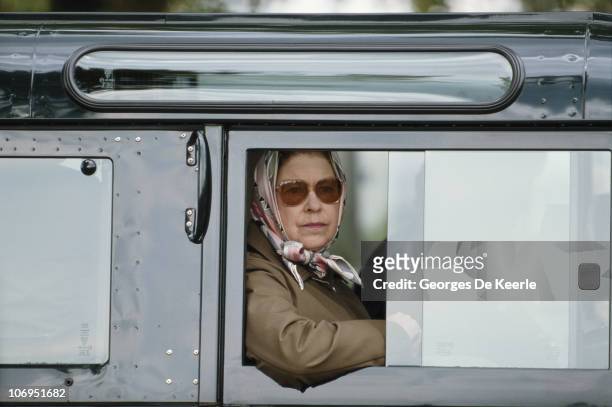 Queen Elizabeth II in a Land Rover during the Royal Windsor Horse Show at Windsor Home Park, Berkshire, 16th May 1987.