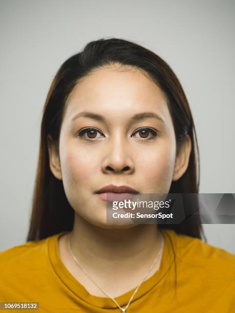 real malaysian young woman with blank expression - mug shot stock pictures, royalty-free photos & images