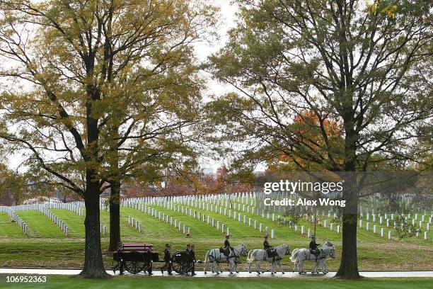 Members of the U.S. Army's 3rd Infantry Regiment 'The Old Guard' escort the caisson carrying the flag-draped casket that holds the remains of Army...