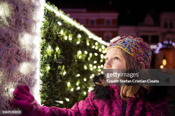 girl looking at christmas lights - girls glamour stock pictures, royalty-free photos & images