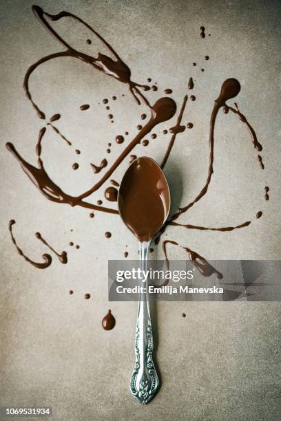 melting chocolate on spoon - syrup splash stock pictures, royalty-free photos & images