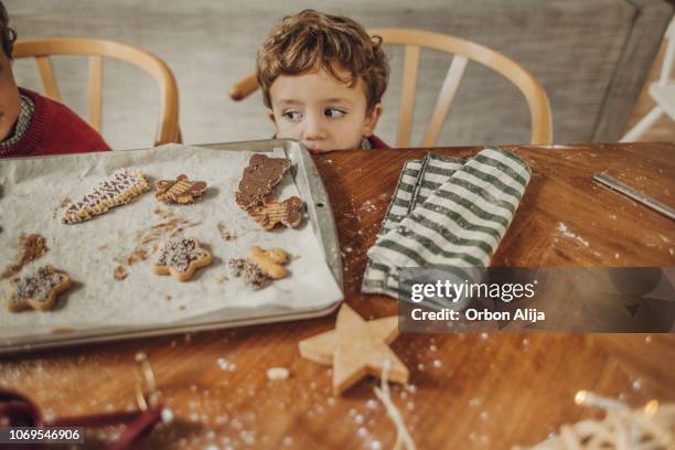 boys cooking christmas cookies - child christmas costume stock pictures, royalty-free photos & images