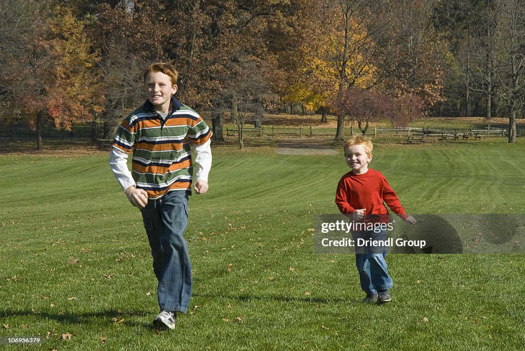 Two Brothers Racing In The Park High-Res Stock Photo - Getty Images