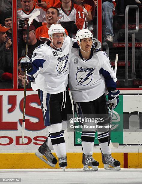 Steven Stamkos of the Tampa Bay Lightning congratulates Steve Downie on his goal at 9:41 of the second period against the Philadelphia Flyers at the...