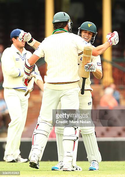 Luke Butterworth and Adam Maher of the Tigers celebrate victory during day three of the Sheffield Shield match between the New South Wales Blues and...