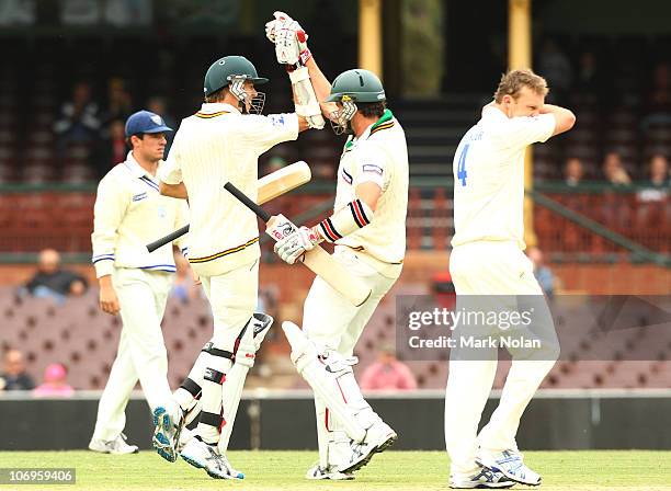 Luke Butterworth and Adam Maher of the Tigers celebrate victory during day three of the Sheffield Shield match between the New South Wales Blues and...