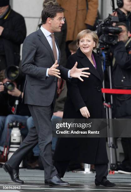 German Chancellor Angela Merkel and Dutch Prime Minister Mark Rutte gesture upon his arrival at the Chancellery on November 19, 2010 in Berlin,...