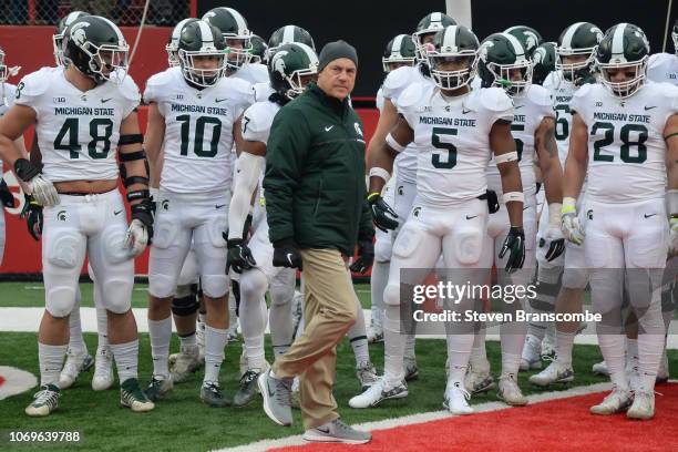 Head coach Mark Dantonio of the Michigan State Spartans walks on the field with the team before the game against the Nebraska Cornhuskers at Memorial...