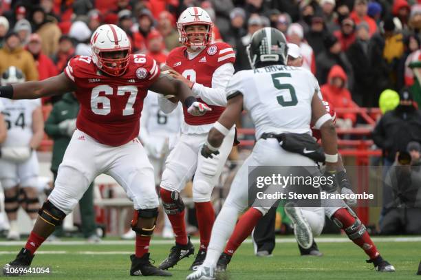 Quarterback Adrian Martinez of the Nebraska Cornhuskers drops back to pass against the Michigan State Spartans at Memorial Stadium on November 17,...