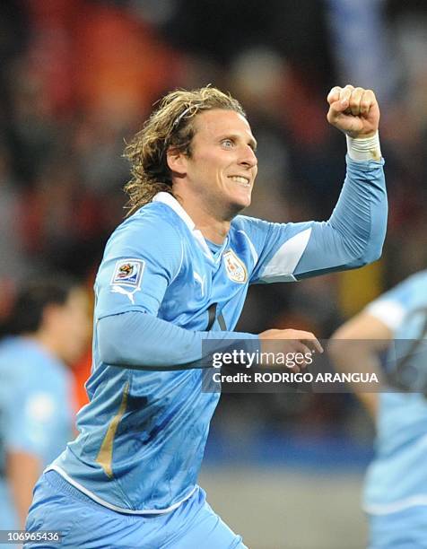 Uruguay's striker Diego Forlan celebrates after he scored Argentina's second goal during the third place World Cup 2010 football match Uruguay versus...