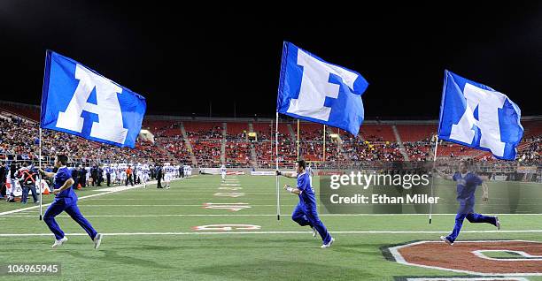 Air Force Falcons cheerleaders run flags through the end zone after an Air Force touchdown against the UNLV Rebels at Sam Boyd Stadium November 18,...