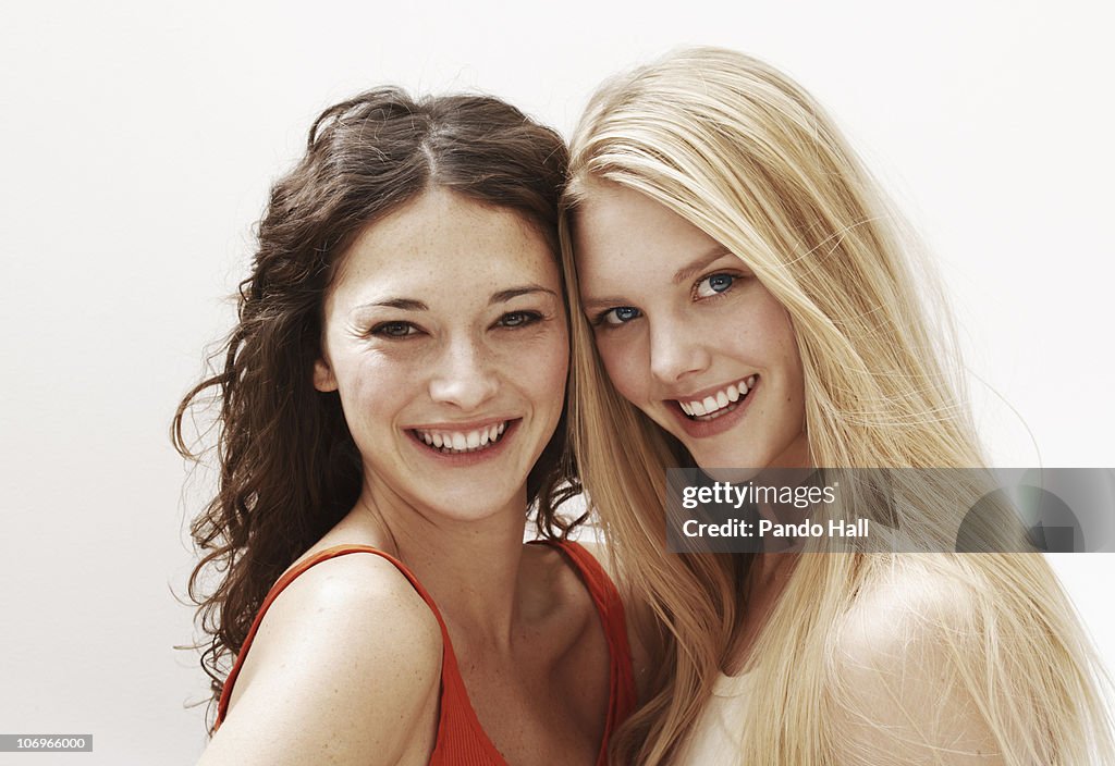 Portrait of two young women smiling, close-up