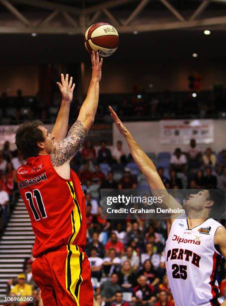 Cameron Tragardh of the Tigers makes a shot under pressure from Jeremiah Trueman of the Wildcats during the round six NBL match between the Melbourne...