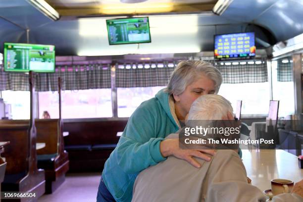 Donna Rock, who was off work, but still helping out, gives a kiss to George Jones, a regular, who she hasn't seen in awhile at the Tastee Diner...