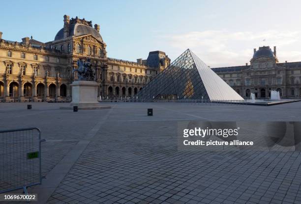 December 2018, France , Paris: The inner courtyard with the pyramid of the Louvre Museum is deserted. France's government fears further riots in the...