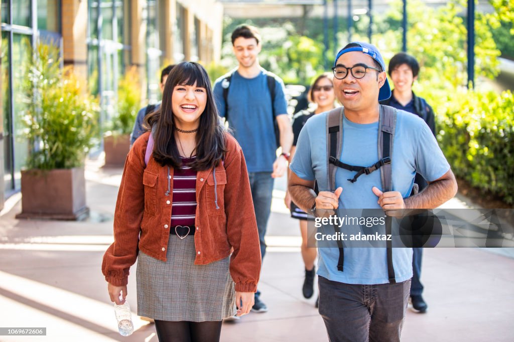 Group of Diverse College Students Walking on Campus