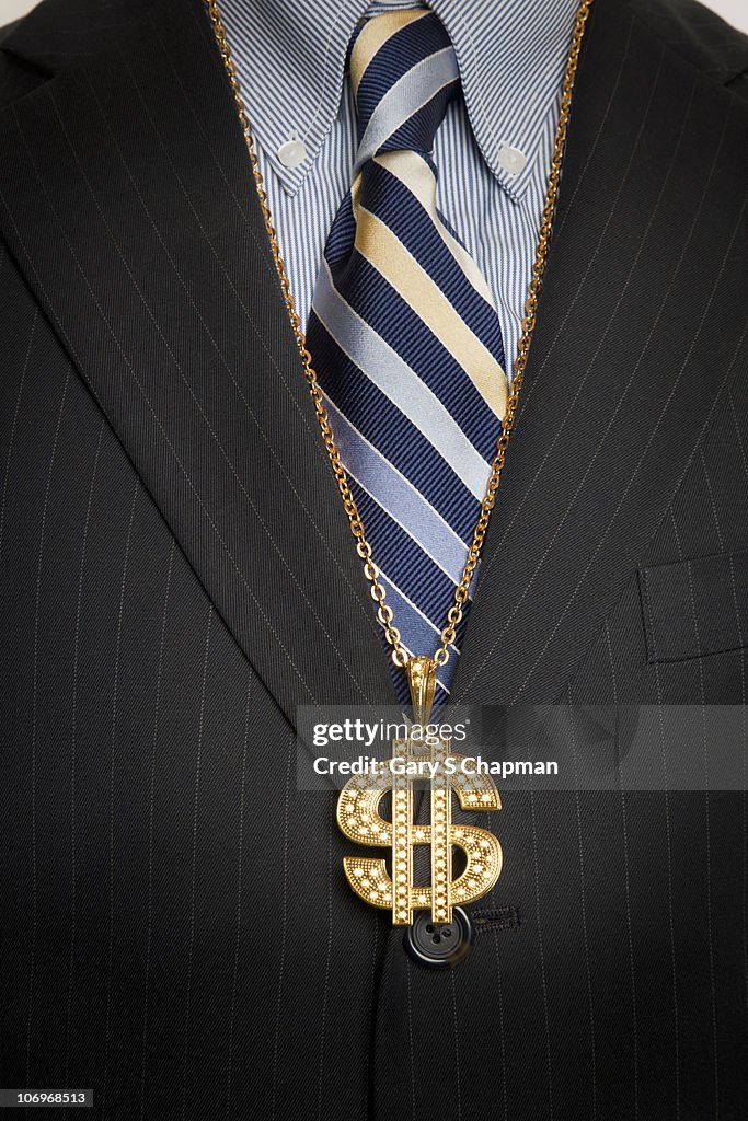 Businessman with gold dollar sign bling necklace