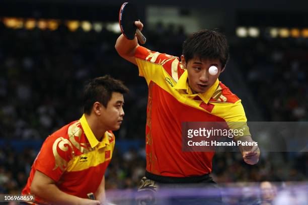 Jike Zhang of China serves in the Men's Doubles Final with Hao Wang of China against Lin Ma and Xin Xu of China at Guangzhou Gymnasium during day...