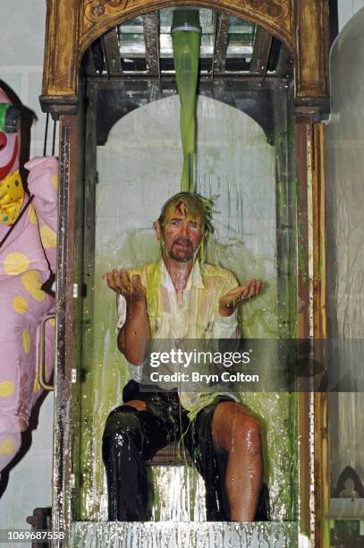 Noel Edmonds, the television personality and host of BBC's Noels House Party, gestures after being 'gunked' in the gunk tank during filming for his...