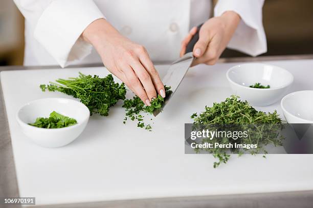 cook chopping fresh parsley  - curly parsley stock pictures, royalty-free photos & images