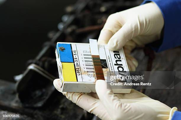 Student uses a test strip for the pH measurement during a sole leather tanning process at the LGR tannery school on November 17, 2010 in Reutlingen,...