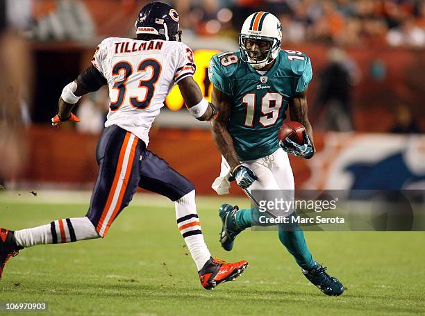 Receiver Brandon Marshall of the Miami Dolphins runs as safety Charles Tillman of the Chicago Bears defends at Sun Life Stadium on November 18, 2010...