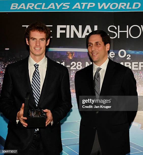 Andy Murray of Scotland receives his trophy from CEO of the ATP Adam Helfant during the Barclays ATP World Tour Finals - Media Day at the County Hall...