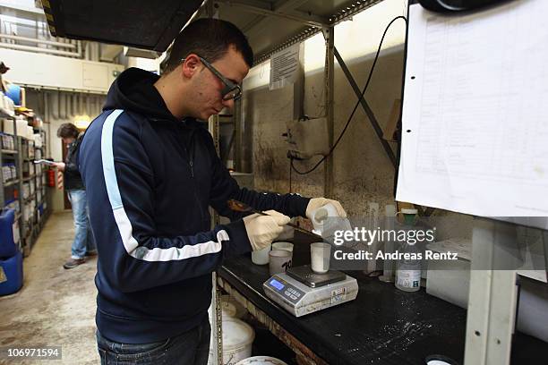 Student Hasan Sari prepares a liquid for a colouration of tanned leather at the LGR tannery school on November 17, 2010 in Reutlingen, Germany. The...