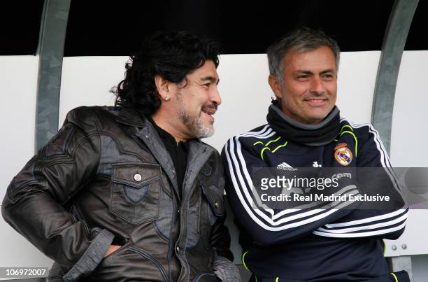 Former Argentina player and manager Diego Maradona chats with head coach Jose Mourinho of Real Madrid during a training session at the Valdebebas...