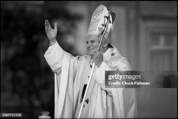 Pope John Paul II waves during an outdoor Mass in Victory Square, Warsaw, Poland, June 2, 1979.