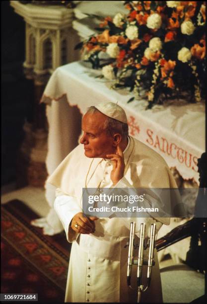 Overhead view of Pope John Paul II as he stands near microphones and touches his ear, Chapel of St Patrick's College, Maynooth, Ireland, October 1,...