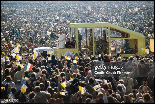 Pope John Paul II as he is driven though waves to the crowd in Phoenix Park after an outdoor Mass, Dublin, Ireland, September 29, 1979.