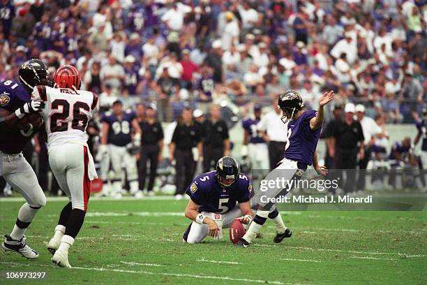 Punter Kyle Richardson holds as Kicker Matt Stover of the Baltimore Ravens kicks a successful field goal against the Cincinnati Bengals during a NFL...