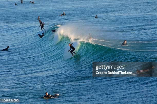 surfing in huntington beach - huntington beach stock pictures, royalty-free photos & images