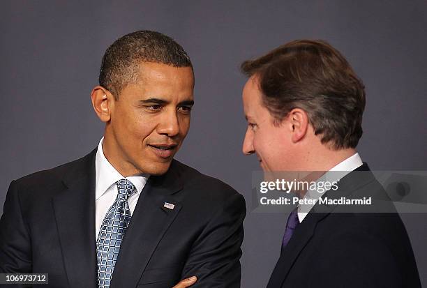 President Barack Obama talks with British Prime Minister David Cameron before an official group portrait at the NATO Summit at Feira Internacional de...