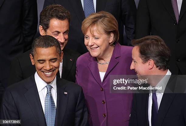 President Barack Obama stands with French President Nicolas Sarkozy , German Chancellor Angela Merkel and British Prime Minister David Cameron during...