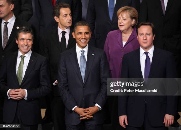 Secretary General Anders Fogh Rasmussen stands with French President Nicolas Sarkozy, US President Barack Obama, German Chancellor Angela Merkel and...