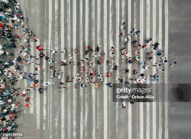 high angle view of people forming and arrow on the street - concepts stock pictures, royalty-free photos & images