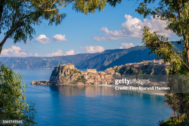 the city of scilla in south italy through a frame of branches - calabria stock-fotos und bilder