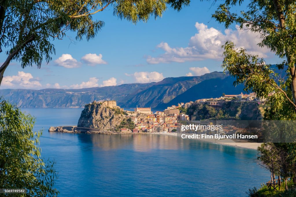 The city of Scilla in South Italy through a frame of branches