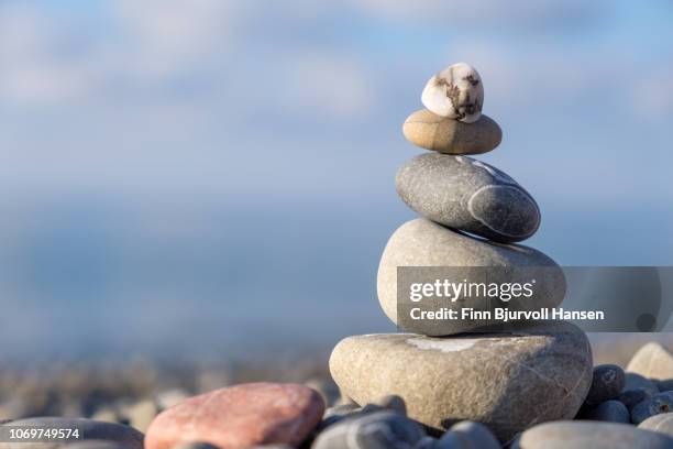 stack of stones on the beach with blurred background - filosofia imagens e fotografias de stock