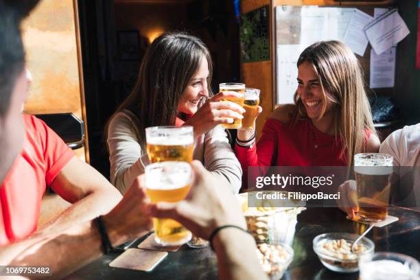 group of happy friends drinking beer at the brewery - irish culture stock pictures, royalty-free photos & images