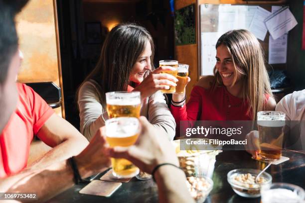 group of happy friends drinking beer at the brewery - london pub stock pictures, royalty-free photos & images