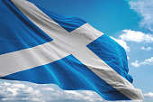 Scotland flag waving cloudy sky background