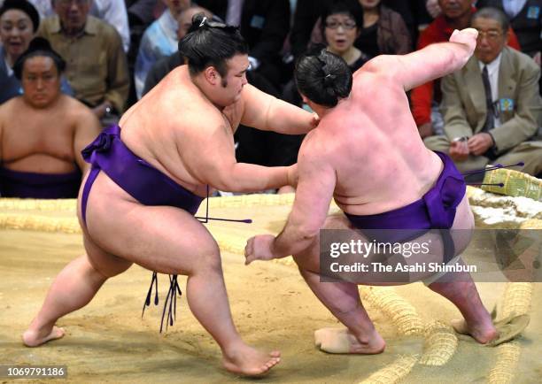 Komusubi Takakeisho pushes Georgian ozeki Tochinoshin out of the ring to win on day nine of the Grand Sumo Kyushu Tournament at Fukuoka Convention...