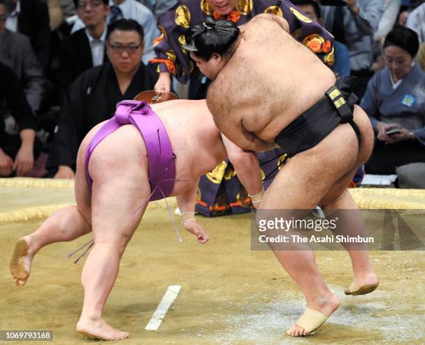 Ozeki Takayasu throws Yoshikaze to win on day nine of the Grand Sumo Kyushu Tournament at Fukuoka Convention Center on November 19, 2018 in Fukuoka,...