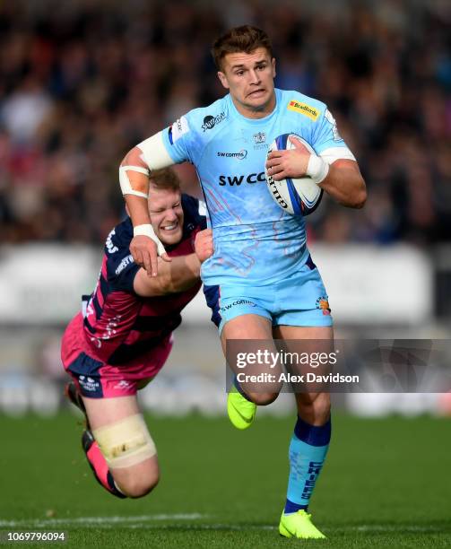 Henry Slade of Exeter Chiefs is tackled by Tom Savage of Gloucester Rugby during the Heineken Champions Cup match between Exeter Chiefs and...