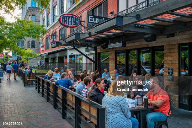 people dine at restaurant patio in downtown boise idaho usa - boise stock pictures, royalty-free photos & images